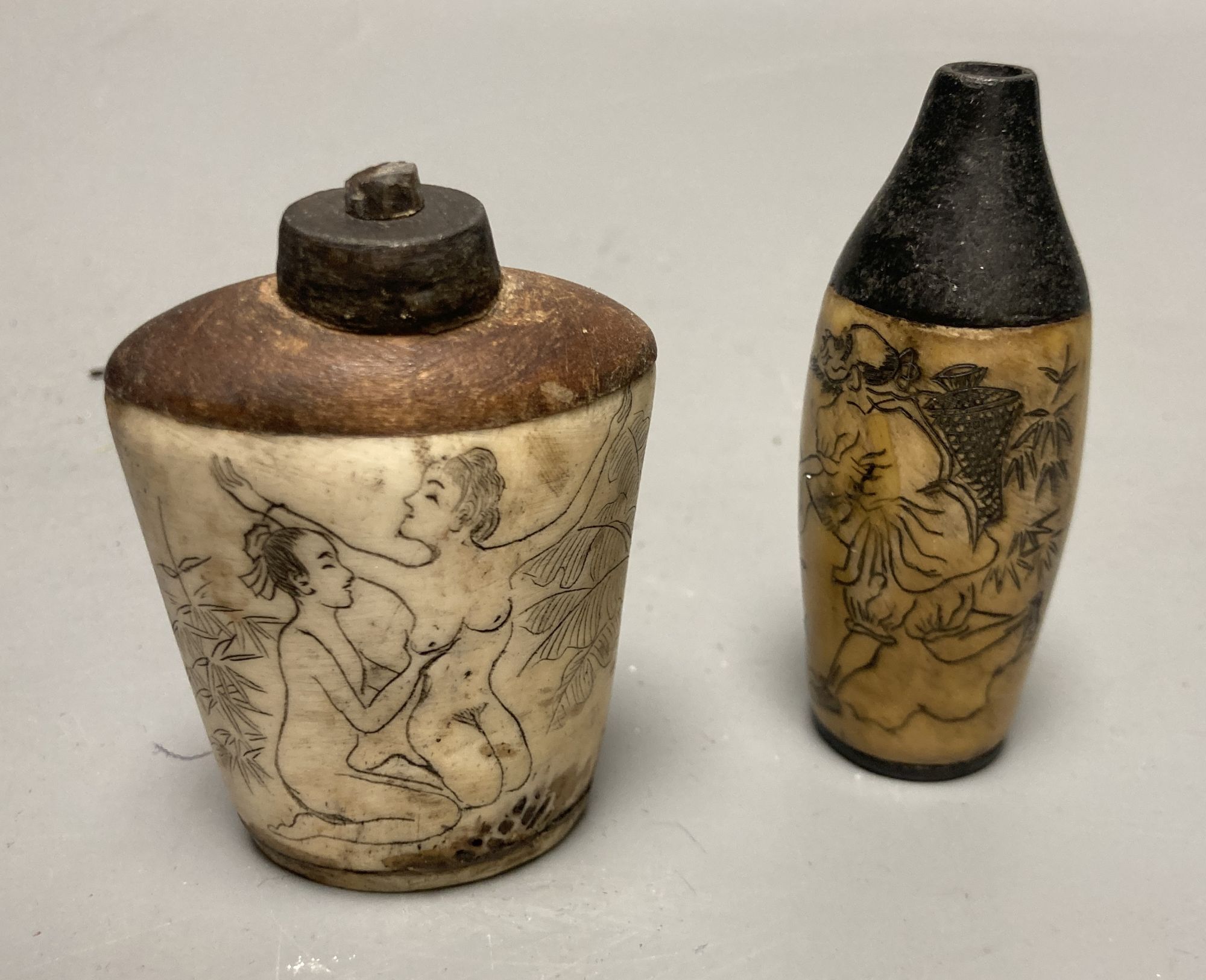 Two Chinese snuff bottles, one with erotic carving, tallest 7cm
